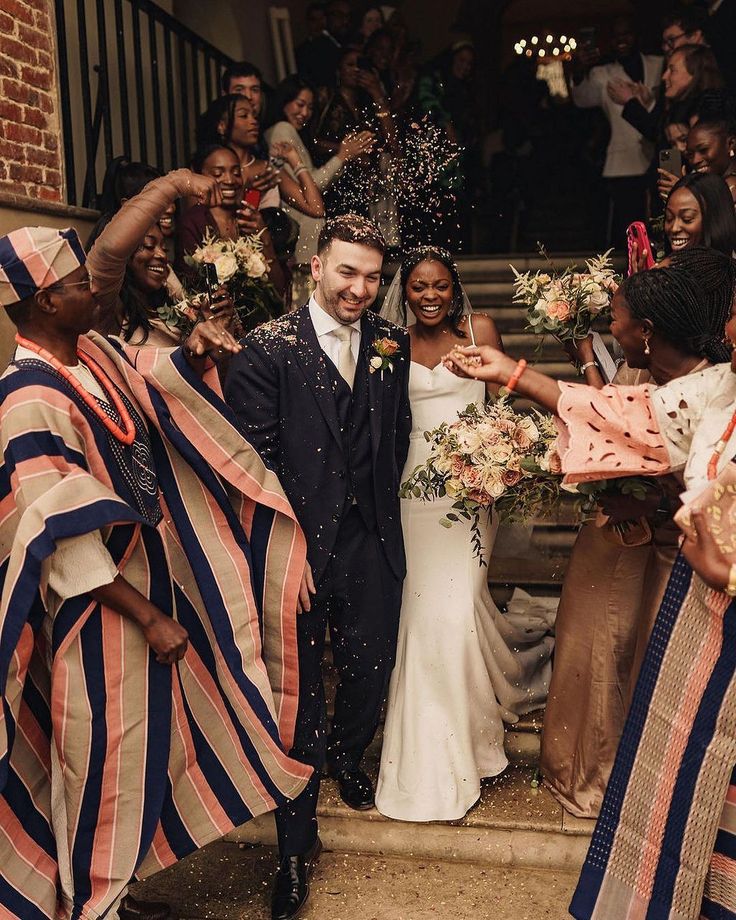 Two families showering a couple with confetti on the steps